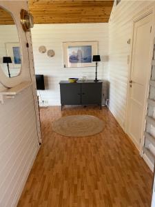 a room with a wooden floor and a table at Vettinghytta, close to the sea with amazing view. in Gravdal