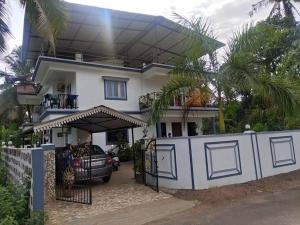a house with a car parked in front of it at Park Grand Boutique 3 Bedroom Bungalow in Marmagao