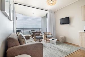 a living room with a couch and a table at Durban Point Waterfront, 805 Quayside 40 Canalquay Rd in Durban