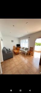 a living room with a couch and chairs and a table at Bonito apartamento con terrazas y aparcamiento. in Son Bou