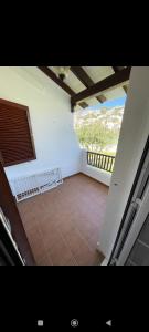 a room with a balcony with a tiled floor at Bonito apartamento con terrazas y aparcamiento. in Son Bou