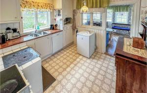 a kitchen with a sink and a dishwasher at Lovely Home In Gräddö With Sauna in Gräddö
