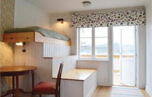 a room with a bunk bed and a desk and a window at Lovely Home In Gräddö With Sauna in Gräddö