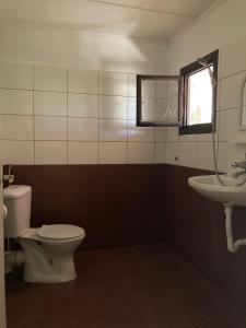 a bathroom with a toilet and a sink at Морска База Венера in Tsarevo