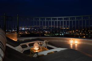 a balcony with a view of a city at night at Amazing view with huge balcony in Veria
