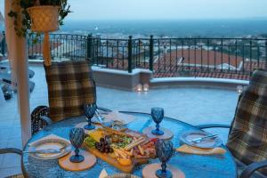 a blue table with a plate of food on it at Amazing view with huge balcony in Veria