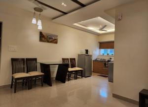 a kitchen and dining room with a table and chairs at Golden Bird Heritage in Arpora
