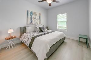 a bedroom with a large bed and a ceiling fan at LandsEnd in Rockport