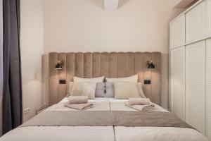 a bedroom with a large bed with a wooden headboard at Apartments Villa Chiara Opatija in Ičići