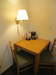 a wooden table with a lamp next to it at Bryce View Lodge Part of the Ruby's Inn Resort in Bryce Canyon