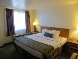 a hotel room with a large bed and a window at Bryce View Lodge Part of the Ruby's Inn Resort in Bryce Canyon +33 photos