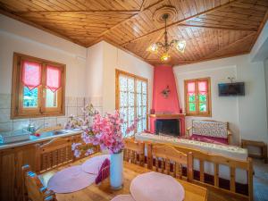 A television and/or entertainment centre at Cherry House in Damouchari with a sea view - Delicious Houses