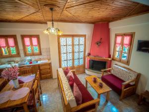 A television and/or entertainment centre at Cherry House in Damouchari with a sea view - Delicious Houses