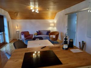 a living room with a table and a couch at HIDE-AWAY Corinna in Drobollach am Faaker See