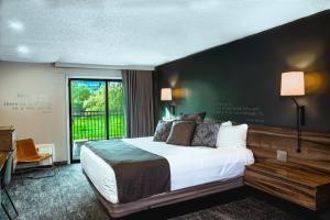 a hotel room with a bed and a large window at Ruby River Hotel in Spokane