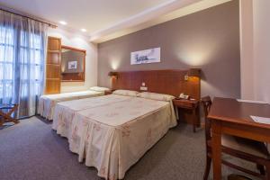 Cama o camas de una habitación en Hotel Herradura