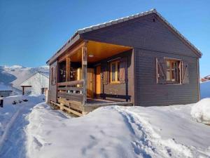 a log cabin in the snow with snow around it at Chalet cosy avec piscine dans la résidence Ignaux - Ax les thermes in Ignaux