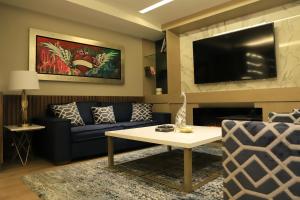 Una televisión o centro de entretenimiento en Alia Inn Boutique WTC