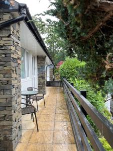 a patio with a table and a bench next to a building at Cheerful 3 bedroom cottage in central location in Ambleside