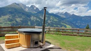 a barbecue grill with a view of a mountain at Panorama Berg Chalet in Großkirchheim