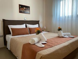 a bedroom with a large bed with towels on it at Luxury Rhodian Panorama in Ixia
