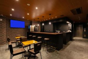 a restaurant with a bar with chairs and a tv at HOTEL TABARD TOKYO - Vacation STAY 64544v in Tokyo