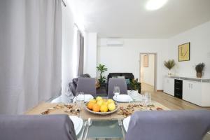 a living room with a table with a bowl of fruit at Mathilda's apartment in Zadar