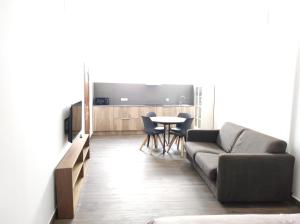 a living room with a couch and a table at Apartamentos Turísticos Betanzos in Betanzos