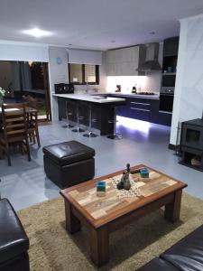 sala de estar con mesa y cocina en Casa en Pingueral 1 en Tomé