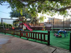 a park with a playground with a slide at Seaside, relaxing family house with playground! Villa Lavrys 3 in Marathi