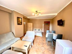 a living room with two beds and a table at Pokoje goscinne Marcin in Łeba