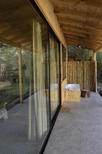um alpendre com uma banheira e janelas em PINAMARTE em Pinamar