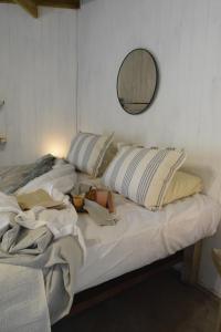 a bed with two pillows and a doll sitting on it at PINAMARTE in Pinamar