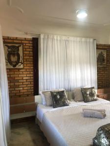 a bedroom with two beds and a window at Hotel Mansão Marcieri in Aquiraz +69 photos