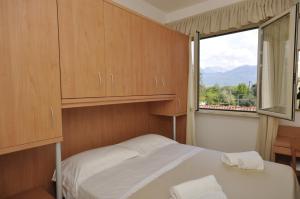 a small bedroom with a bed and a window at Hotel Airone in Marina di Pietrasanta +30 photos