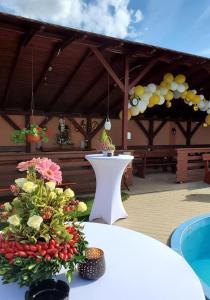 a pavilion with a table with flowers on it at Pensiunea Roua Muntilor in Vadu Crişului +126 photos