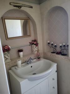 a bathroom with a sink and a mirror at Белият кът in Sapareva Banya +79 photos