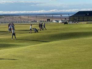 a group of people walking on a golf course at St Andrews Holiday Home Walk to the Old Course in St. Andrews