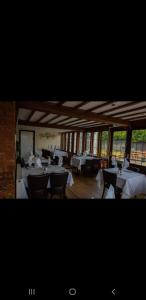 a dining room with white tables and chairs at Queens Head Inn in Evesham