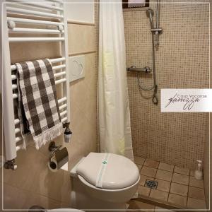 a small bathroom with a toilet and a shower at Trullo Fanizza in Alberobello