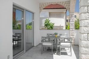 a table and chairs on the balcony of a house at Perla Luxury Apartment in Vodice