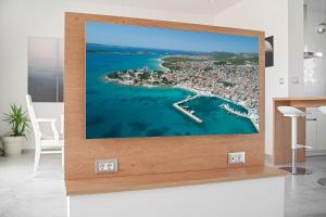 a tv screen with a picture of a harbor at Perla Luxury Apartment in Vodice