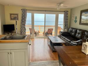 a living room with a couch and a table at Cozy LAKE ONTARIO WATERFRONT Breathtaking Views! in Pulaski