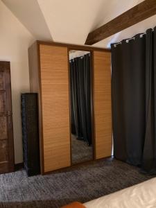 a mirror in a bedroom with black curtains at La Sognare, ahol az álom valóra válik in Leányfalu