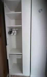 an empty white refrigerator with its door open at SARA Apart BelleView in Sinaia