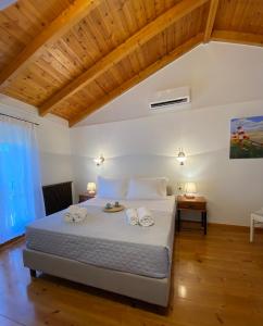 a bedroom with a bed with two towels on it at Myrtillo I Luxury Traditional House in Spanokhórion