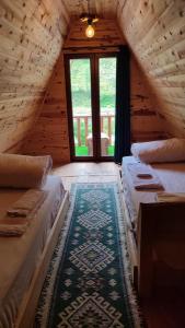 a attic room with two beds and a window at ELASYA BUNGALOV in Rize