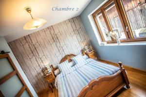 a bedroom with a bed and a wooden wall at Gîte le coeur d'Alsace in Boofzheim +53 photos
