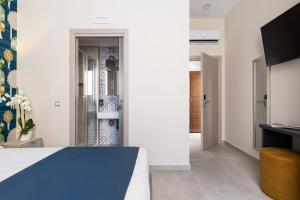 a bedroom with a bed and a tv in a room at Torre Mola Suite in Formia