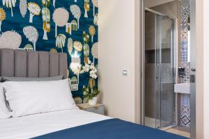 a bedroom with a bed with a blue and white wallpaper at Torre Mola Suite in Formia